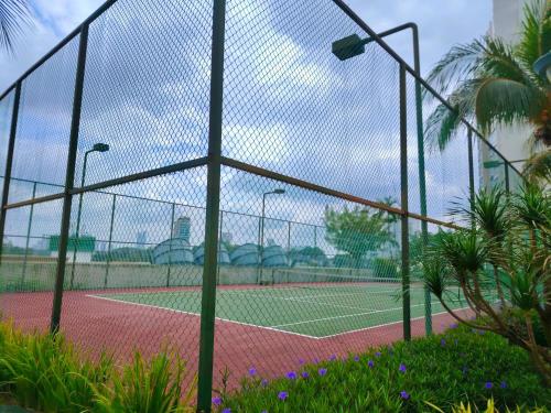 a tennis court with a net on a tennis court at Astonishing Ocean View 3 Bedroom Apartment in Johor Bahru