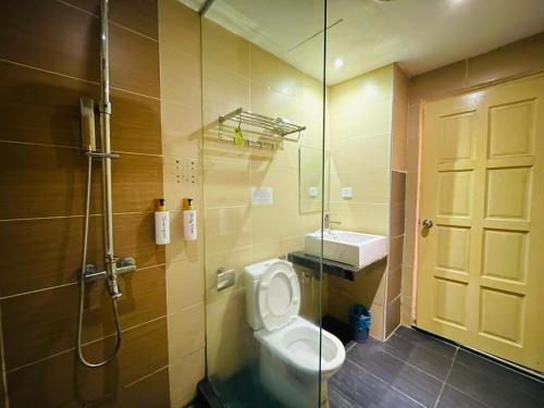 a bathroom with a shower and a toilet and a sink at The Grandeur in Melaka