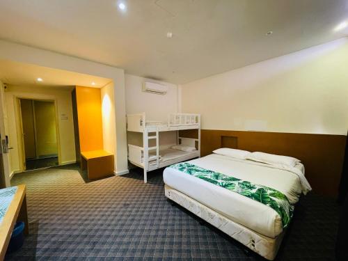 a hotel room with a large bed and a desk at The Grandeur in Melaka