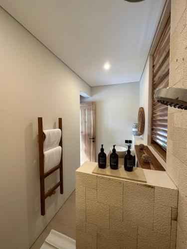 a kitchen with a counter with three black containers on it at Villa Elior Selong Belanak, South Lombok in Selong Belanak