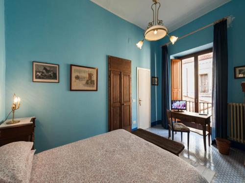 a blue bedroom with a bed and a desk at Dimora del Prete di Belmonte in Venafro