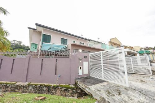 a house with a fence in front of it at Spacious 12 pax Landed Homestay By NexxField in Ampang