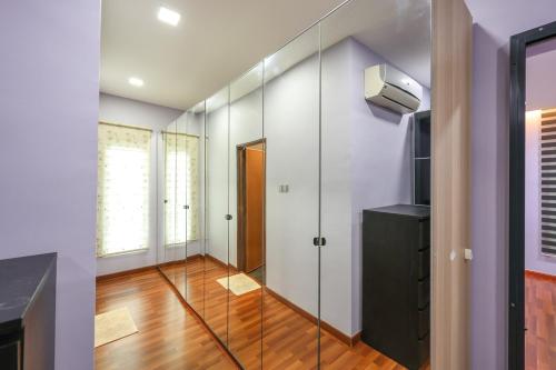 a room with a glass door and a television at Spacious 12 pax Landed Homestay By NexxField in Ampang