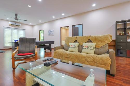 a living room with a couch and a table at Spacious 12 pax Landed Homestay By NexxField in Ampang