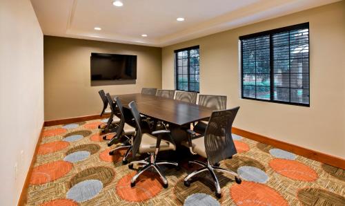 a dining room with a table and chairs at Staybridge Suites - Charlotte Ballantyne by IHG in Charlotte
