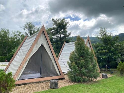 a tent that is sitting in the grass at Take Time Nature Resort in Ban Tha Sai