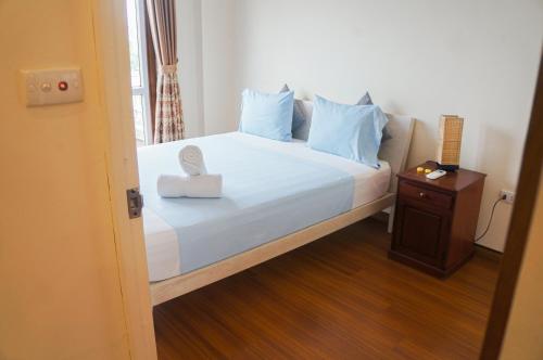 a bedroom with a bed with a box on it at WECOZY HANOI - Railway Side, The Old Quarter in Hanoi