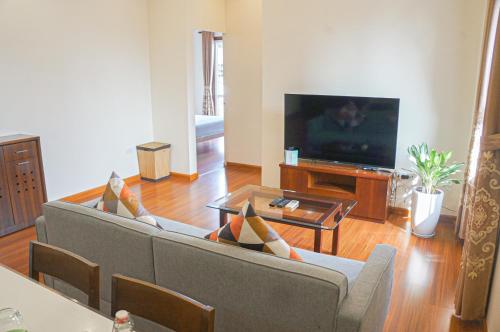 a living room with a couch and a tv at WECOZY HANOI - Railway Side, The Old Quarter in Hanoi