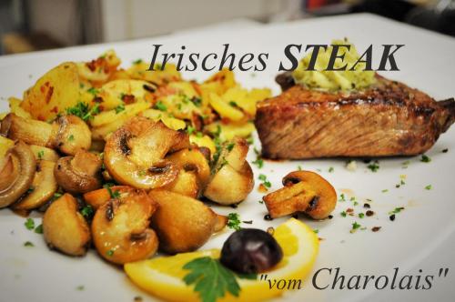 a plate of food with fish and potatoes and mushrooms at Hotel Meyerhoff in Ostrhauderfehn