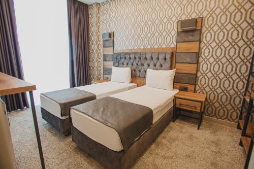 Ένα ή περισσότερα κρεβάτια σε δωμάτιο στο Prusias Otel