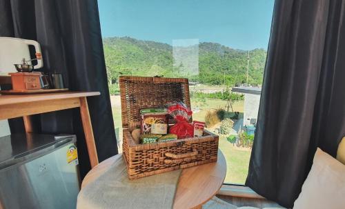 a basket sitting on a table in front of a window at Take Time Nature Resort in Ban Tha Sai