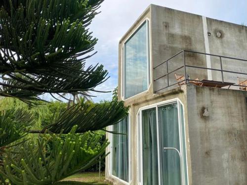 a building with a balcony on top of it at Take Time Nature Resort in Ban Tha Sai