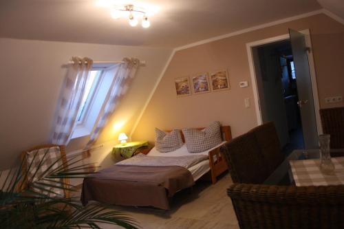 a small bedroom with a bed and a window at Romantik Landhaus in Dresden