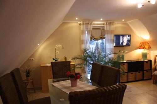 a dining room with a table and chairs and a dining room at Romantik Landhaus in Dresden