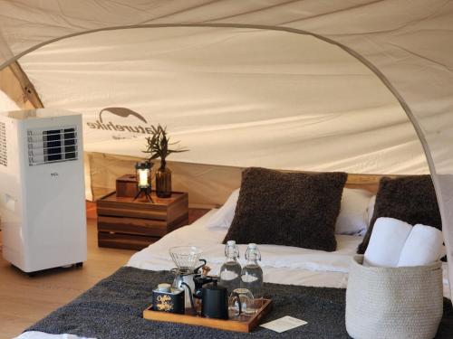a bedroom with a bed in a tent at Take Time Nature Resort in Ban Tha Sai
