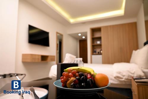 a bowl of fruit on a table in a hotel room at Andalus Hotel in Baghdad