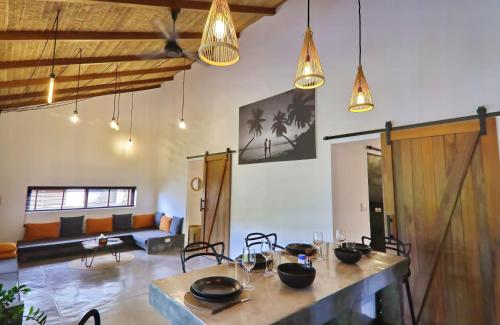 a living room with a table and a couch at Jenna in Koh Phangan