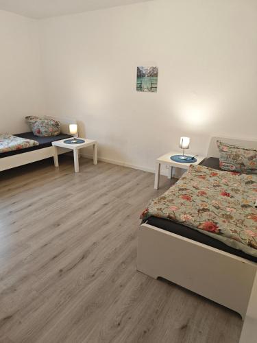 a bedroom with two beds and two tables at IaM 3 Zimmer 90 qm Küche Badezimmer kraftraum 44 u in Plettenberg