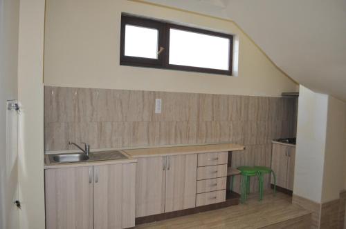 a kitchen with a sink and a window at Vila RAZA - locatie centrala in Eforie Nord