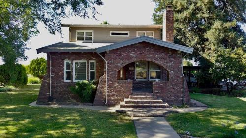 a red brick house with stairs in a yard at Wine Country Oasis Private Pool & Spa in Acampo