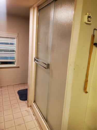 a shower door in a bathroom with a window at Wine Country Oasis Private Pool & Spa in Acampo