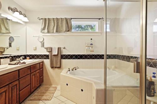 a bathroom with a tub and a sink and a shower at Wine Country Oasis Private Pool & Spa in Acampo