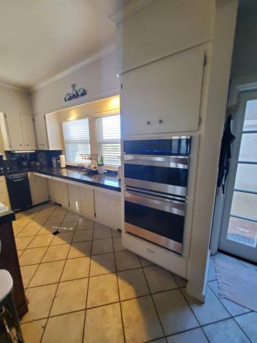 a kitchen with white cabinets and a counter top at Wine Country Oasis Private Pool & Spa in Acampo