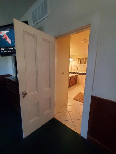 a door leading into a room with a television at Wine Country Oasis Private Pool & Spa in Acampo