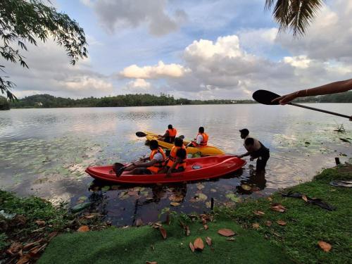a group of people in a canoe on a lake at MYH - Lake Front Pvt Villa with Staff and Includes FREE Breakfast of your choice in Bandaragama