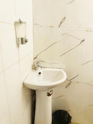 a white bathroom with a sink and a mirror at Viet Vintage Hostel n Pub - Soft mattress - Free Breakfast in Hanoi