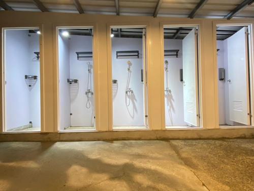 a row of glass doors with white horses in them at 藍貝島潛水背包旅宿一館 Lambay Island Dive Hostel I in Xiaoliuqiu