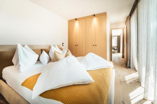 a bedroom with a white bed with white pillows at Ariane's Guesthouse in Sesto