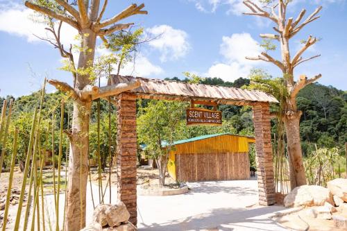 a brick archway with a sign that reads guest house at Scent Chalet D - Village in Da Lat