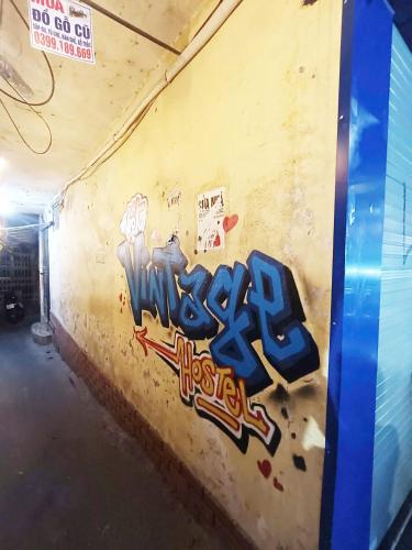 a wall with graffiti on the side of a building at Viet Vintage Hostel n Pub - Soft mattress - Free Breakfast in Hanoi