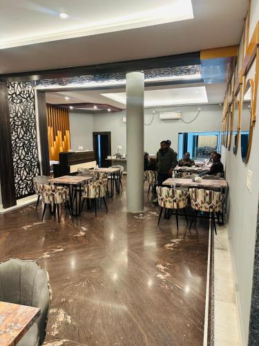 a dining room with tables and a piano at Hotel The Grand Agastya in Kaohni