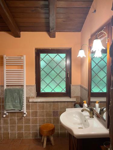 a bathroom with a sink and a window at Agriturismo Le Grotte in Nemi