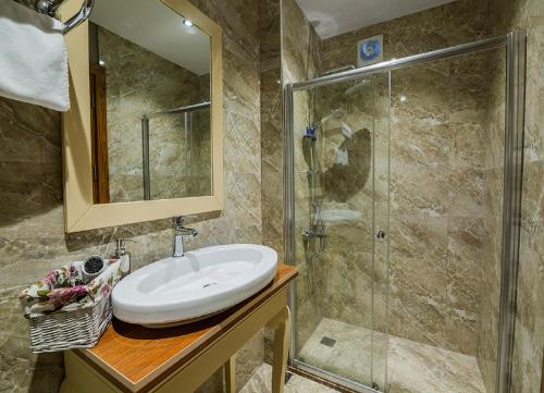 a bathroom with a sink and a shower at Million Old City Apartment in Istanbul