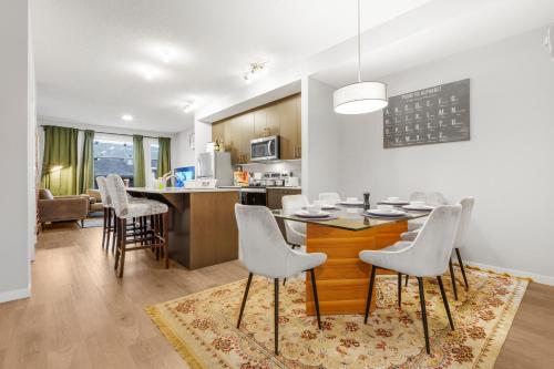 a kitchen and living room with a table and chairs at Private Master Bed Room SPRING in Edmonton