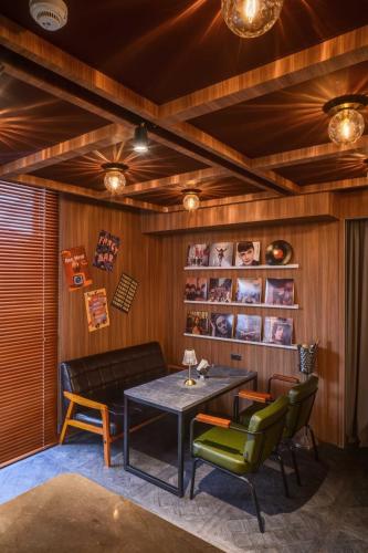 a dining room with a table and green chairs at Fun Stay Inn Ximen in Taipei