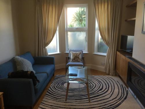 a living room with a couch and a coffee table at Rugby Lodge in Dublin