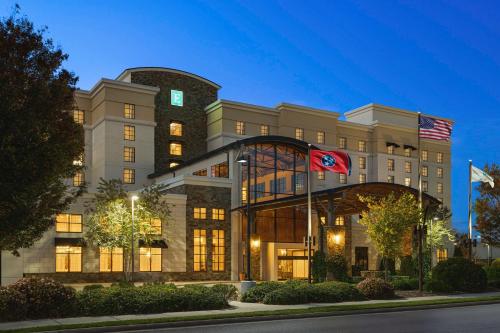 a building with two flags in front of it at Embassy Suites Chattanooga Hamilton Place in Chattanooga