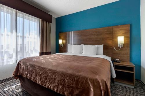 a hotel room with a bed and a large window at Quality Inn & Suites I-35 E-Walnut Hill in Dallas