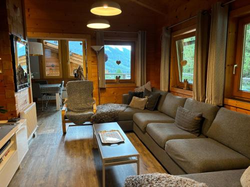 a living room with a couch and a table at Luxury Filzmoos Chalet in Filzmoos