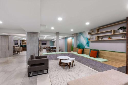 a living room with a couch and a table at Wyndham Garden Louisville KY in Louisville