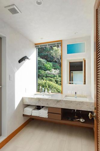 a bathroom with a large sink and a window at The TRAVELERS Chateau Tateyama in Haraoka