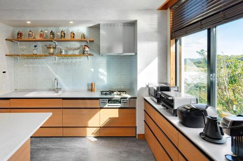 a kitchen with a sink and a counter top at The TRAVELERS Chateau Tateyama in Haraoka