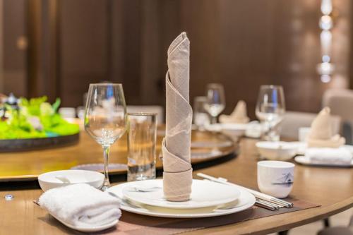 a table with a plate with a napkin on it at Radisson Hotel, Beijing DaXing Airport in Beijing