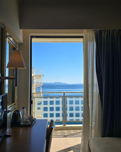 a room with a desk and a window with a view at Chios Chandris in Chios
