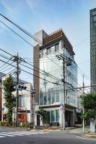 a tall glass building with a lot of windows at The SAUNA Escape Shibuya in Tokyo
