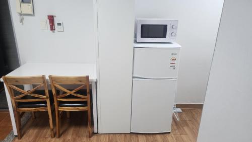 a microwave sitting on top of a refrigerator at Kiman09 in Seoul